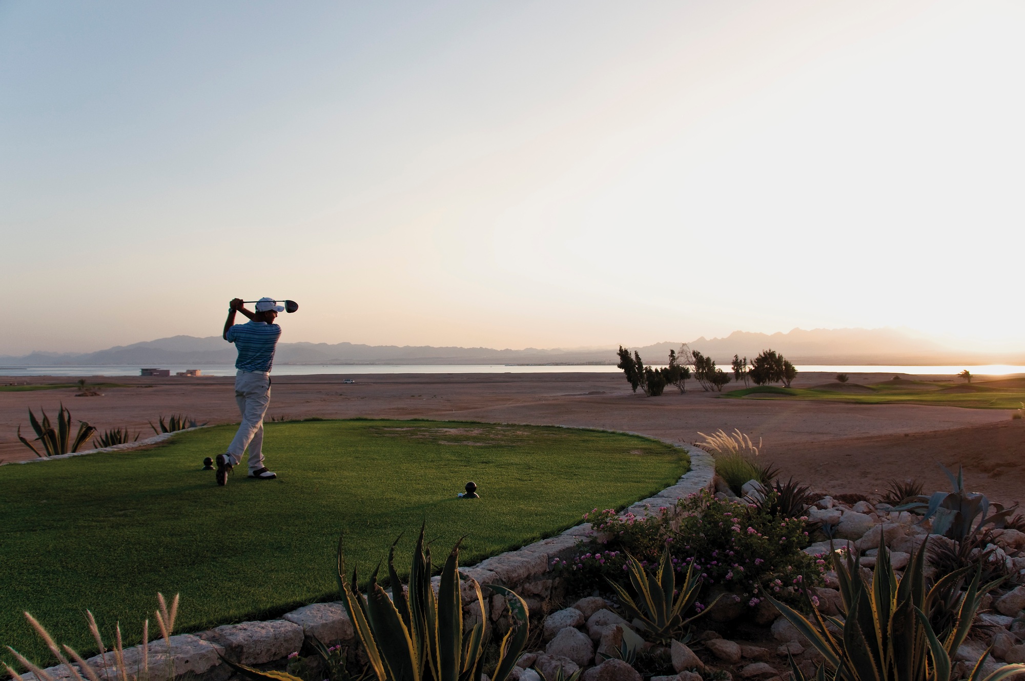 Egypt, Man playing golf on golf course