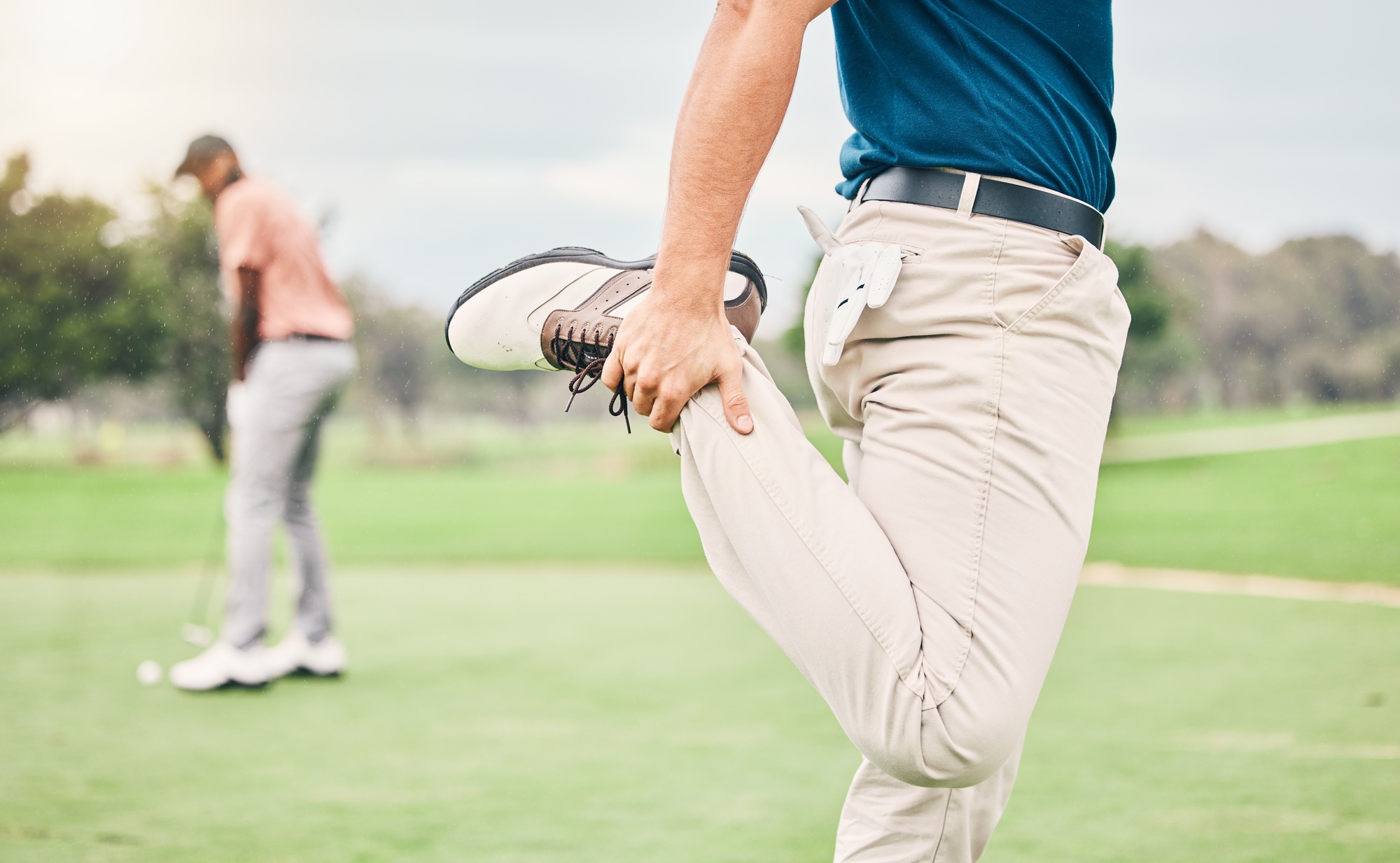 Golf, sports and man stretching legs on course for game, practice and training for competition. Pro